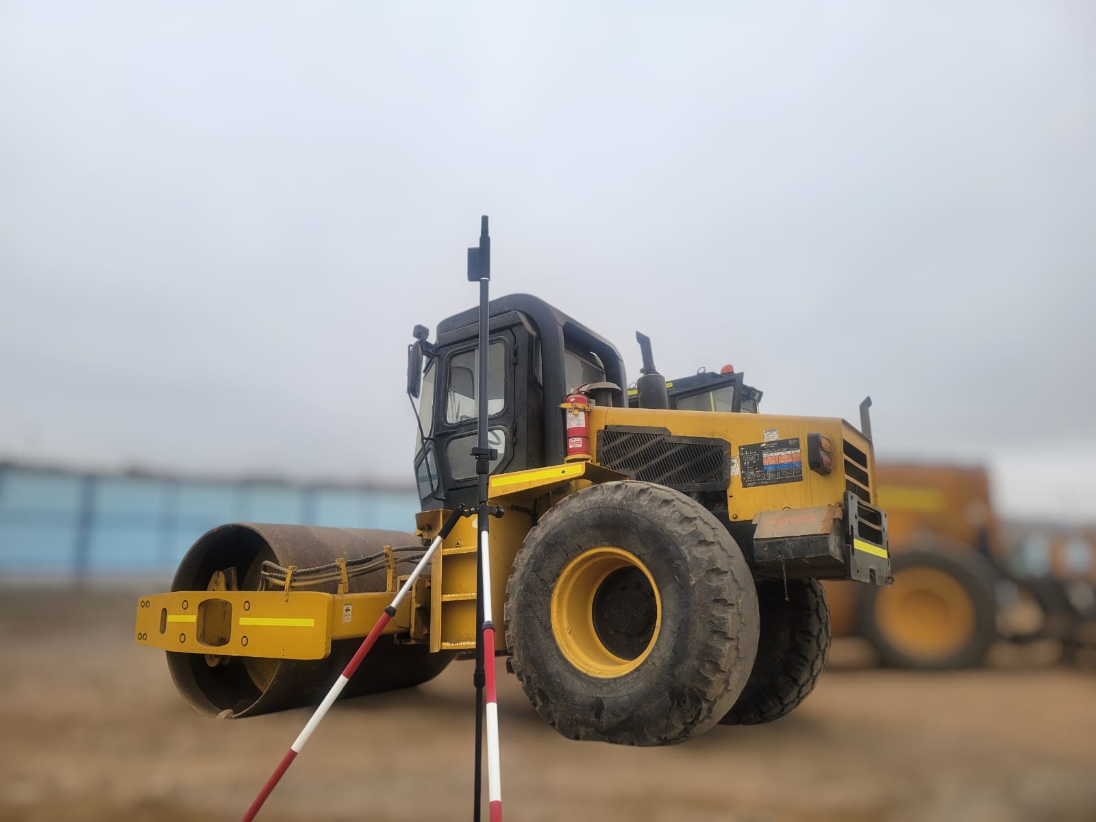 ROLAVI GNSS receiver beside heavy construction equipment