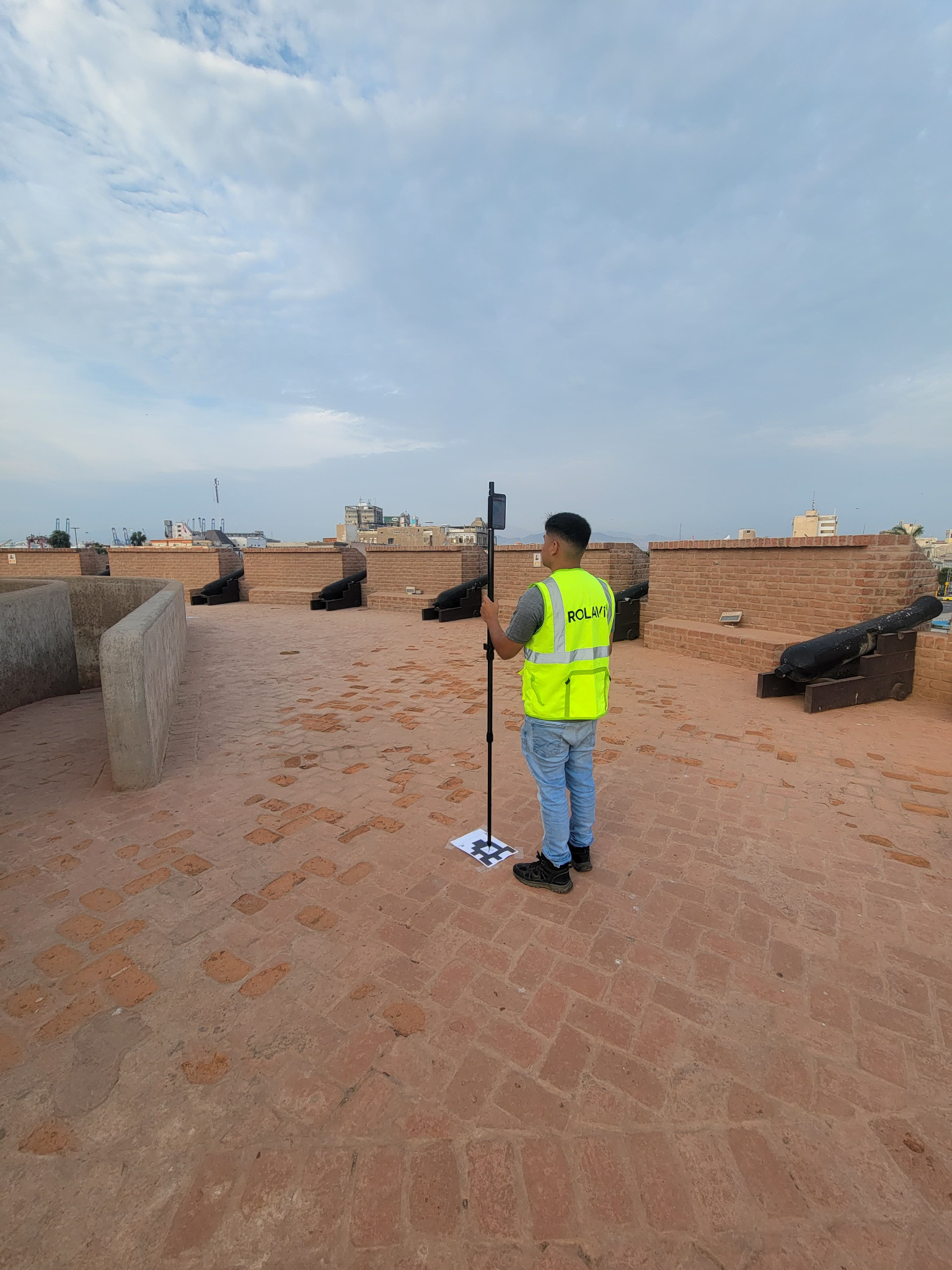 Surveyor with ROLAVI GNSS setup at a historic site
